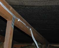 Speaker Cable Tacked to roof joist 